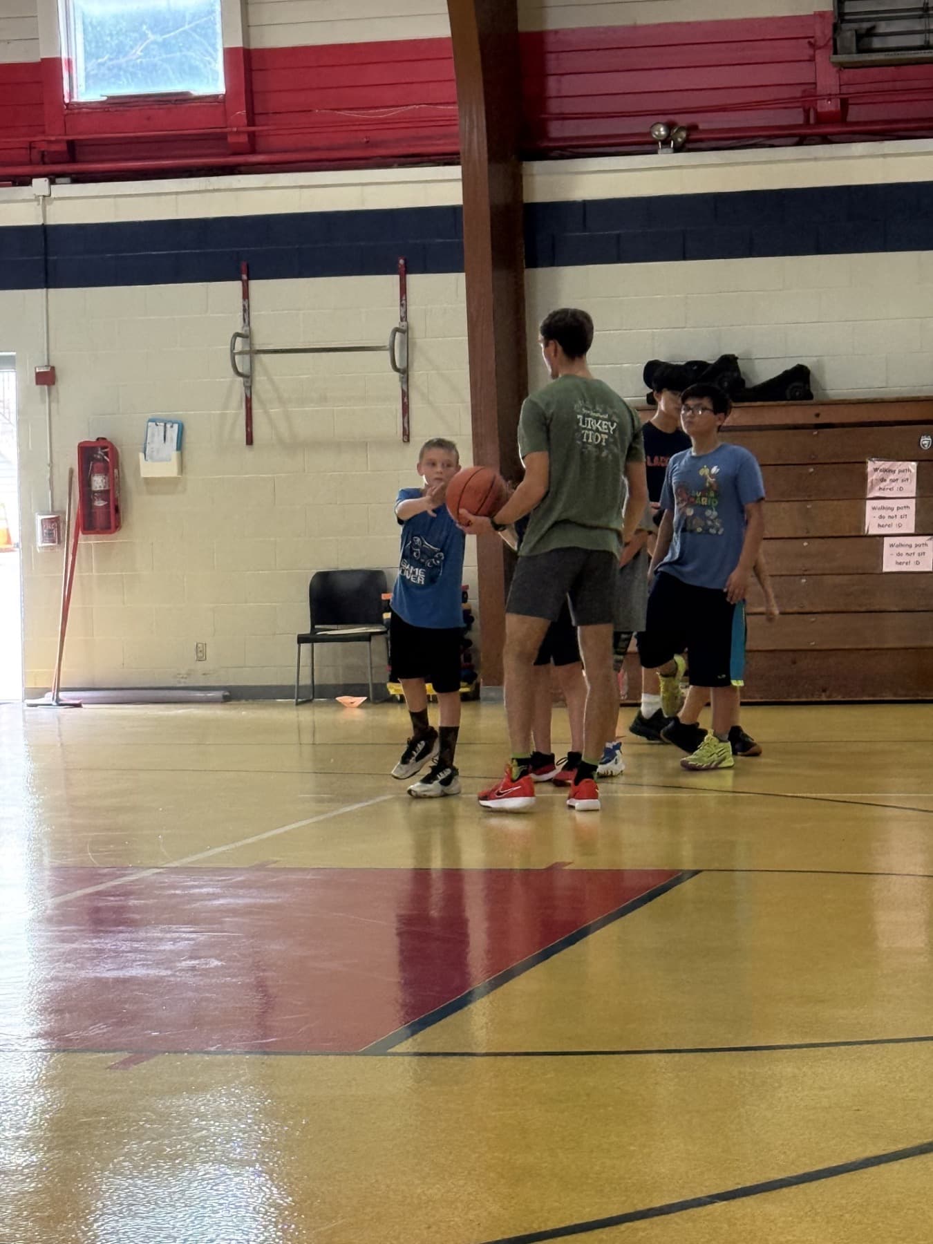 Ryan coaching young basketball players during an in person session
